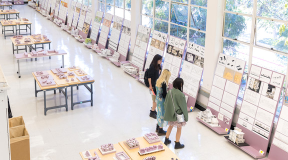 Students browse colleagues' projects in Perloff Hall Studio