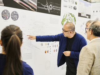 Faculty showing guests work from his studio at the end of year exhibition