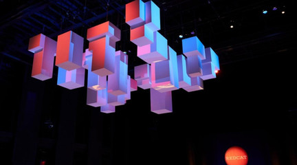 Gala design showing hanging boxes lit with red, purple and pink lighting