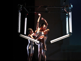 Image of dancers interacting with robotic arms