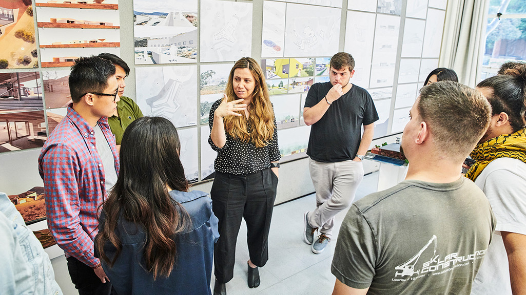 Image of faculty chatting with students