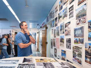 A photograph showing a series of architectural images, each on a square page, assembled across a wall like pixels