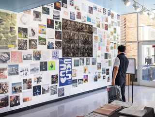 A photograph showing a series of architectural images, each on a square page, assembled across a wall like pixels