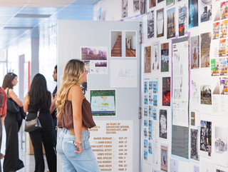 A photograph showing a series of architectural images, each on a square page, assembled across a wall like pixels