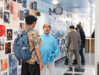 A photograph showing a series of architectural images, each on a square page, assembled across a wall like pixels