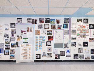 A photograph showing a series of architectural images, each on a square page, assembled across a wall like pixels