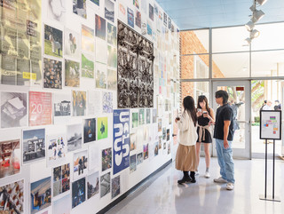 A photograph showing a series of architectural images, each on a square page, assembled across a wall like pixels