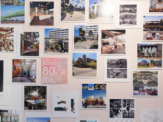 A photograph showing a series of architectural images, each on a square page, assembled across a wall like pixels