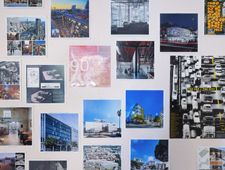 A photograph showing a series of architectural images, each on a square page, assembled across a wall like pixels