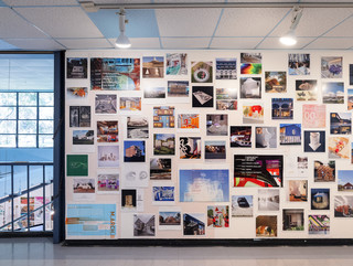 A photograph showing a series of architectural images, each on a square page, assembled across a wall like pixels