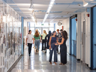 A photograph showing a series of architectural images, each on a square page, assembled across a wall like pixels